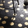 Black-and-gold-hexagonal-mosaic-tiles-with-a-chair-and-lantern-on-the-floor Large Mixed Metal Hexagon Floor Mosaic Tiles