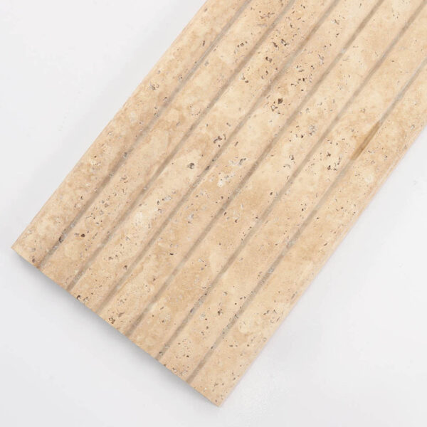 angled-view-of-ribbed-beige-stone-tile Long Beige Travertine Fluted Stone Strip Wall Tile
